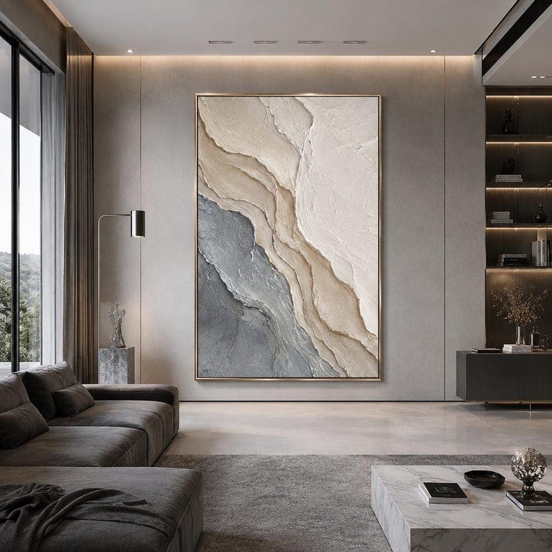 Oversized textured artwork installed in a contemporary interior with architectural lighting.